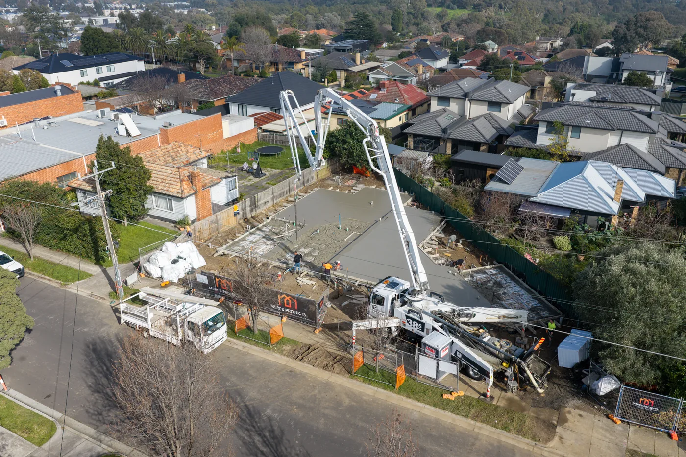 Aerial drone view of a concrete pump working on a residential building site in Melbourne