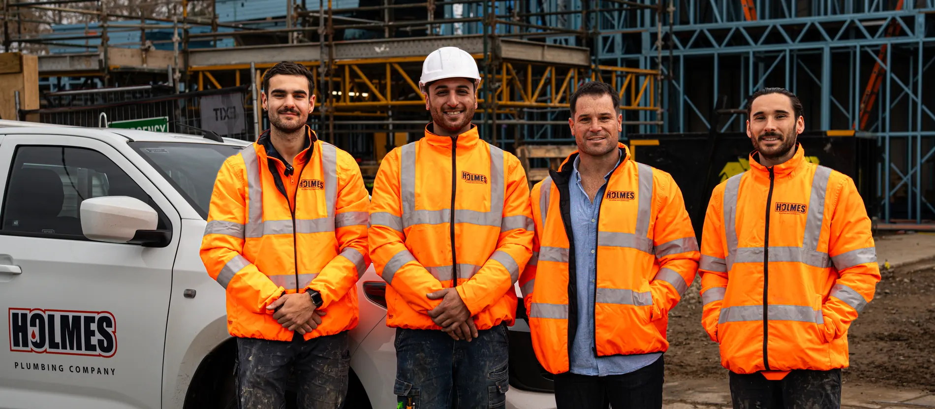 The Holmes Plumbing team in front of their ute on site in Prahran