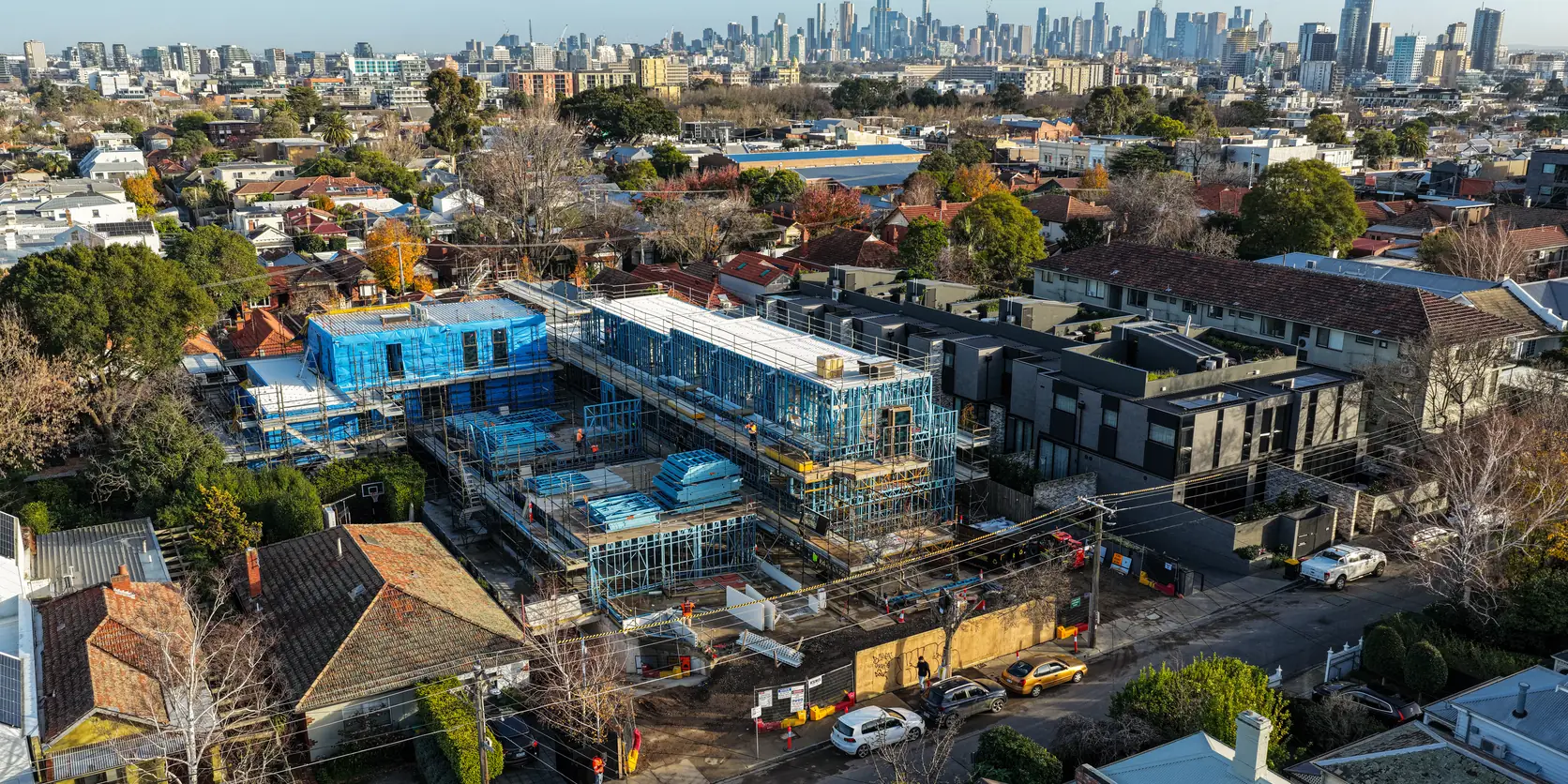 Drone view of the Prahran townhouse development with the Melbourne skyline behind