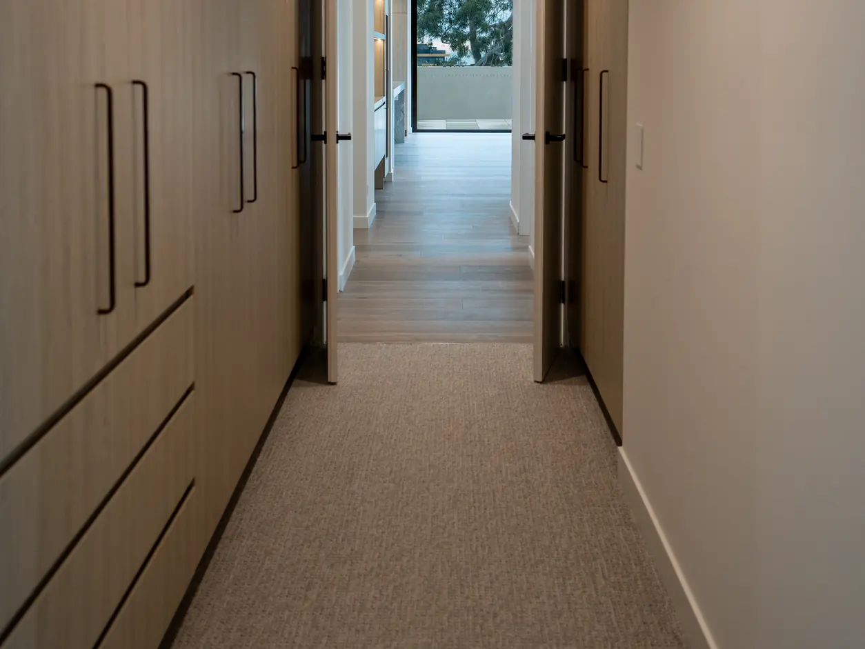 Hallway with floor-to-ceiling doors and built-in joinery