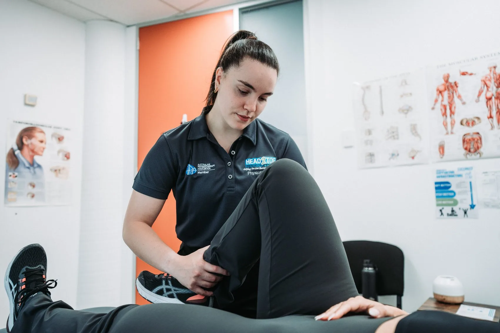 Head 2 Toe physiotherapist assessing a patient's leg