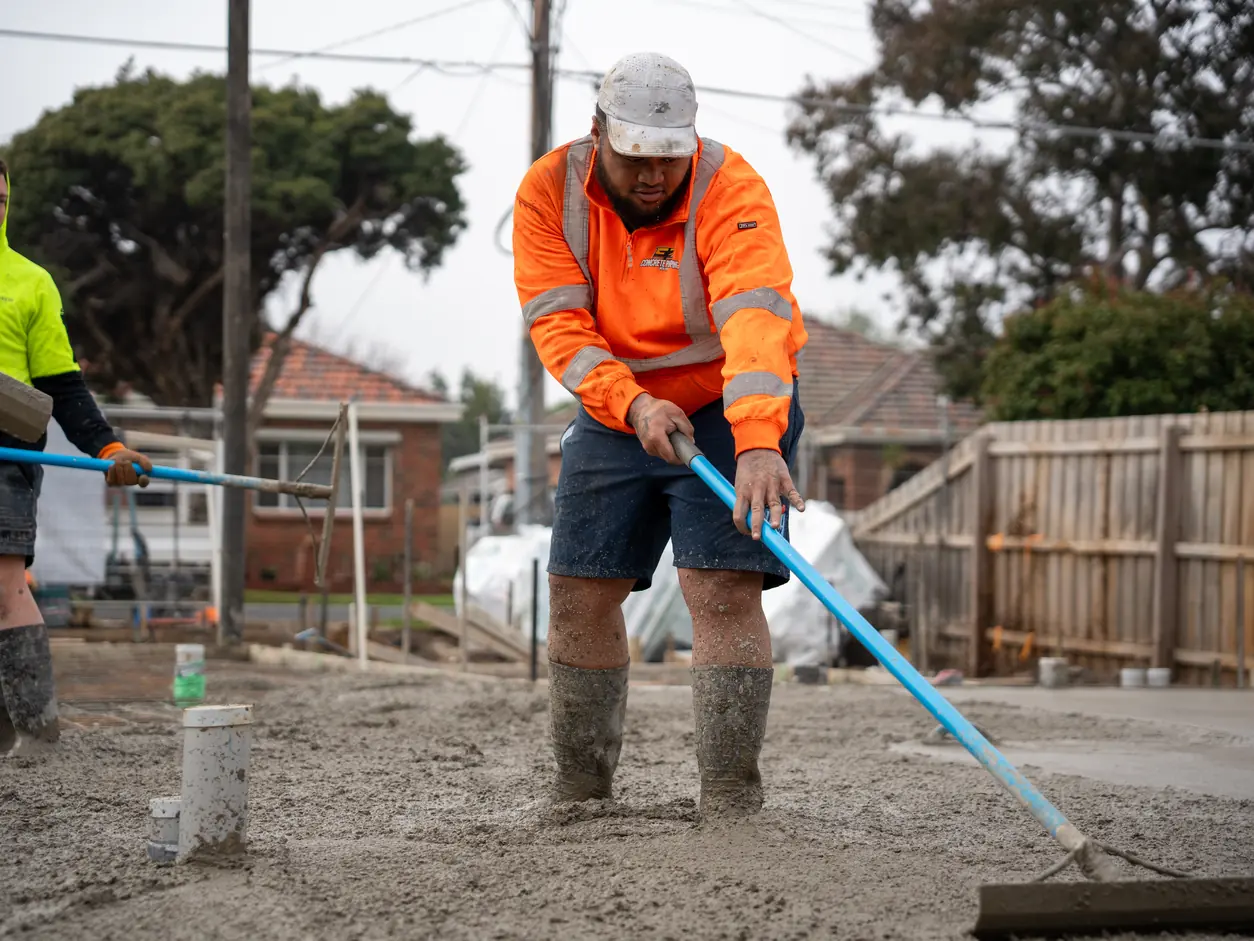 Concreter raking the pour on the Elizabeth slab