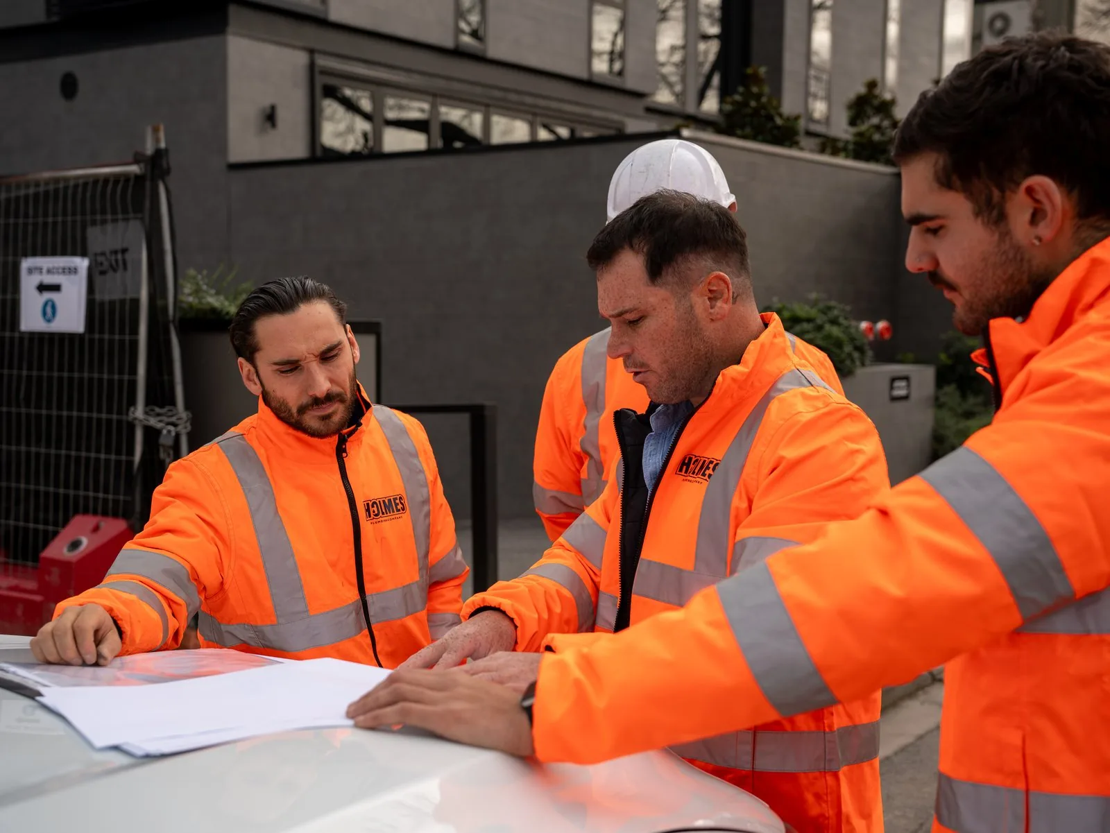 Site crew reviewing plans on a residential development, Melbourne